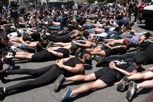 LGBTQ community members join Black Lives Matter demonstrators lie face down depicting George Floyd during his detention by police, blocking an intersection in protest over Floyd's death, in West Hollywood, Calif., on Wednesday, June 3, 2020. Image: AP Photo/Richard Vogel
