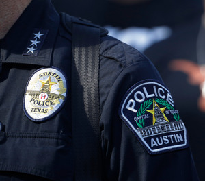 Members of the Austin police department march with members of the University of Texas football team to the State Capitol in Austin, on Thursday, June 4, 2020.