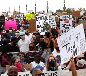 Protesters march on the MacArthur Bridge during a rally in Detroit, Friday, June 5, 2020 over the death of George Floyd. (AP Photo/Paul Sancya)