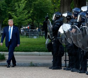 In this Monday, June 1, 2020, file photo President Donald Trump walks past police in Lafayette Park after visiting outside St. John's Church across from the White House in Washington. (AP Photo/Patrick Semansky, File)
