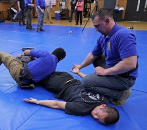Washington State Criminal Justice Training Commission instructors conduct a demonstration of takedown and restraint techniques, which are part of the more than 700 hours of training police and other officers are required to go through in the state.