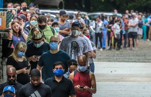 Voters wait in line before voting at the Park Tavern polling place in Atlanta on Tuesday, June 9, 2020. Image: John Spink/Atlanta Journal-Constitution via AP