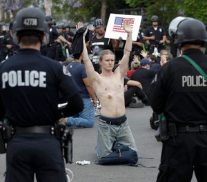 The move comes a day after the board of the Los Angeles Unified School District voted to immediately cut its school police budget by a third. (AP Photo/Marcio Jose Sanchez, File)