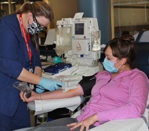 Aubrie Cresswell, 24, donates convalescent plasma at the Blood Bank of Delmarva Christiana Donor Center in suburban Newark, Del.