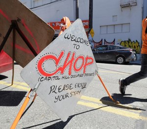 A sign welcomes visitors Monday, June 22, 2020, near an entrance to what has been named the Capitol Hill Occupied Protest zone in Seattle. Police plan to return to their precinct in the zone
