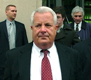 Michael Conahan, center, leaves the federal courthouse in Scranton, Pa.