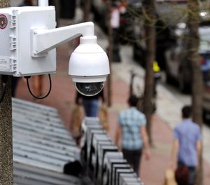 In this April 14, 2014, file photo, a surveillance camera is attached to a light pole along Boylston Street in Boston. (AP Photo/Steven Senne, File)