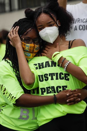 In this June 20, 2020, photo, Ke'Moriae Font, left, hugs Mihrell Reece while listening to a speaker during a youth-led demonstration in Los Angeles calling for an end to racial injustice and for police accountability. Image: AP Photo/Marcio Jose Sanchez