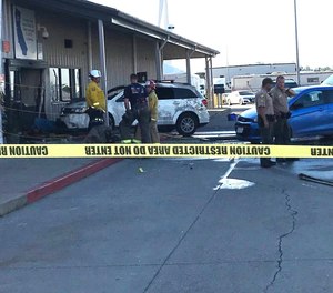 Deputies and firefighters stand outside the Red Bluff Walmart distribution center after a man reportedly opened fire there and rammed his vehicle into the building, Saturday, June 27, 2020, in Red Bluff, Calif.