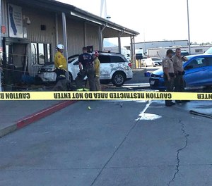 Deputies and firefighters stand outside the Red Bluff Walmart distribution center after a man reportedly opened fire there and rammed his vehicle into the building, Saturday, June 27, 2020, in Red Bluff, Calif. (Damon Arthur/The Record Searchlight via AP)