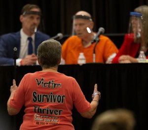 Jane Carson-Sandler, a 1976 rape victim of Golden State Killer Joseph James DeAngelo, stands and gives a double thumbs up to agree with a prosecutor's statement.