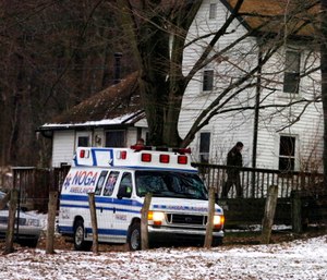 An ambulance is parked outside the farmhouse where Kenzie Marie Houk was killed in Wampum, Pa. (AP Photo/Beaver County Times, Kevin Lorenzi)