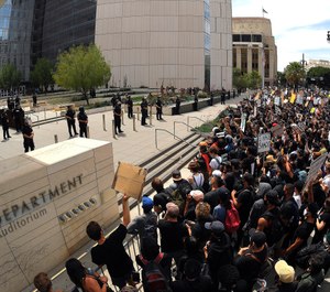 In this June 2, 2020, file photo, demonstrators kneel in front of LAPD headquarters during a protest in Los Angeles over the death of George Floyd. (AP Photo/Mark J. Terrill, File)