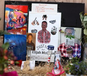 A makeshift memorial stands at a site across the street from where Elijah McClain was stopped by Aurora, Colo., Police Department officers. The Colorado Department of Public Health and Environment has announced it is reopening its investigation into the use of ketamine to sedate McClain during his arrest.