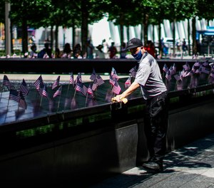 A worker disinfects the area of one of the reflecting pools at the 9/11 Memorial Plaza on July 4, 2020. The Tunnel to Towers Foundation is planning an in-person, socially distanced name-reading ceremony with the families of 9/11 victims in lieu of the official in-person ceremony, which was canceled due to the COVID-19 pandemic.