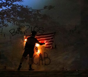 Protesters burn a U.S. flag in downtown Portland, Ore. on July 4, 2020. (Beth Nakamura/The Oregonian via AP, File)
