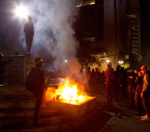 Protesters gather near a fire in downtown Portland, Ore. on July 4, 2020.