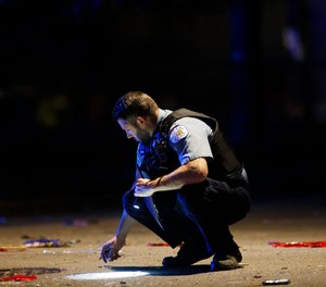 An officer investigates the scene of a shooting in Chicago on July 5, 2020.