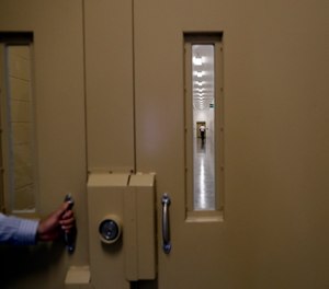 A man walks in a hallway at the Otay Mesa Detention Center in San Diego. (AP Photo/Gregory Bull)