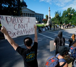 Demonstrators protest in front of a confederate statue at the State House on Friday, July 10, 2020, in Columbia, S.C.