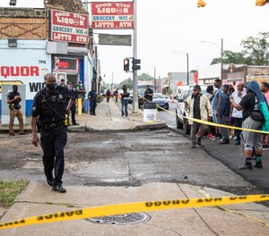Residents in the area confront Detroit Police officers following the fatal shooting of a man, Friday, July 10, 2020, who the city’s police chief said fired at officers investigating a Fourth of July block party shooting, in Detroit. (Junfu Han/Detroit Free Press via AP)