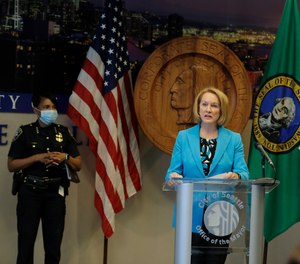 Seattle Mayor Jenny Durkan, center, speaks Monday, July 13, 2020, during a news conference at City Hall in Seattle as Police Chief Carmen Best, left, looks on.