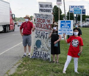 Protesters against the death penalty gather in Terre Haute, Ind., Monday, July 13, 2020. (AP Photo/Michael Conroy)