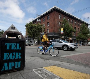 In this July 18, 2019, file photo, traffic and pedestrians cross Telegraph Avenue in Berkeley, Calif. (AP Photo/Jeff Chiu, File)