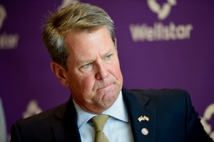 Georgia Gov. Brian Kemp prepares to sign House and Senate bills at Wellstar Kennestone Hospital where the hospital opened a new Emergency Room space, Thursday, July 16, 2020, in Marietta, Ga. Image: AP Photo/Mike Stewart