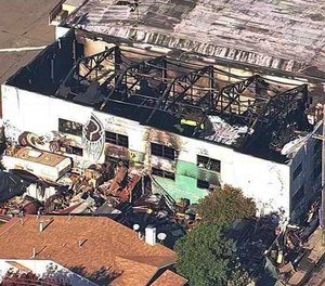 This Dec. 3, 2016, image shows the Ghost Ship Warehouse after a fire swept through the building in Oakland, Calif. Oakland will pay $32.7 million to settle lawsuits filed over the fire that killed 36 people at an illegally converted warehouse.