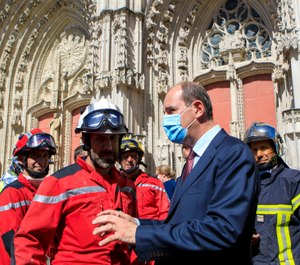 French Prime minister Jean Castex meets firefighters after the blaze at the Gothic St. Peter and St. Paul Cathedral in Nantes, France. The fire evokes memories of the devastating blaze in Notre Dame Cathedral in Paris last year. (AP Photo/Laetitia Notarianni, Pool)