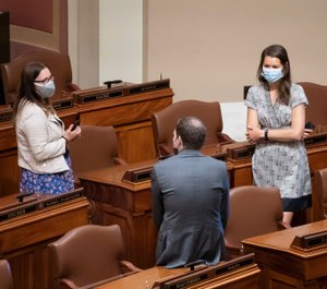 Democratic State Reps, Rep. Jamie Becker-Finn, DFL-Roseville, Rep. Jamie Long, DFL-Minneapolis, and Rep. Liz Olson, DFL-Duluth talk at the start of the special session Monday, July 20, 2020 in St. Paul, Minn. (Glenn Stubbe/Star Tribune via AP)
