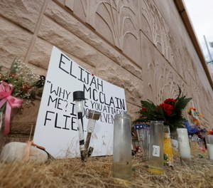 In this July 3, 2020, file photo, a memorial site across the street from where Elijah McClain was stopped by Aurora, Colo. (AP Photo/David Zalubowski, File)