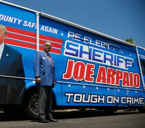 Former Maricopa County Sheriff Joe Arpaio, poses for a photograph in front of his campaign vehicle as he is running for the position of Maricopa County Sheriff again, Wednesday, July 22, 2020, in Fountain Hills, Ariz. AP Photo/Ross D. Franklin)
