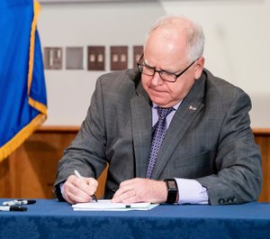 Gov. Tim Walz signed into law a sweeping package of police accountability measures Thursday, July 23, 2020, in St. Paul, Minn.(Glen Stubbe/Star Tribune via AP)