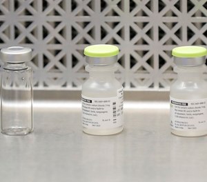 This March 16, 2020 file photo shows vials used by pharmacists to prepare syringes used on the first day of a first-stage safety study clinical trial of the potential vaccine for COVID-19 at the Kaiser Permanente Washington Health Research Institute in Seattle. The world's biggest COVID-19 vaccine test got underway Monday, July 27 with the first of 30,000 planned volunteers.
