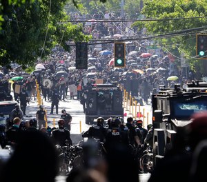 Police try to hold a line with protesters July 25, 2020, during a Black Lives Matter protest near the Seattle Police East Precinct headquarters in Seattle. (AP Photo/Ted S. Warren)