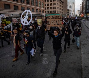 Black Lives Matter protesters march through downtown Oakland on Saturday, July 25, 2020, in Oakland, Calif. (AP Photo/ Christian Monterrosa)