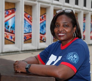 Karen Calloway, principal of Kenwood Academy in Chicago, poses Tuesday, July 28, 2020, for a portrait outside the Hyde Park neighborhood campus. (AP Photo/Charles Rex Arbogast)