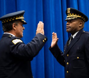 In this July 15, 2020, photo, retiring Chicago Police Department First Deputy Superintendent Anthony Riccio, left, swears in newly-promoted Deputy Chief of Criminal Networks Dion Boyd during a promotion ceremony at CPD headquarters in Chicago. (Ashlee Rezin Garcia/Chicago Sun-Times via AP)