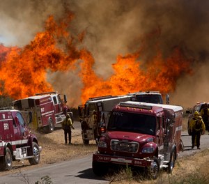 Roughly 2,300 fire personnel are battling the Apple fire in California, which had grown to 26,000 acres as of Monday. (AP Photo/Ringo H.W. Chiu)