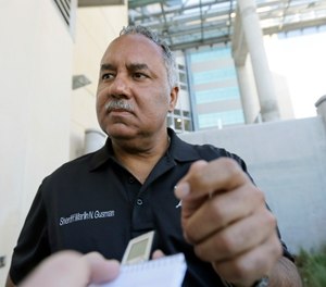 Marlin Gusman, sheriff of New Orleans, speaks outside a new jail facility in New Orleans as buses transferring inmates from the old jail arrive. (AP Photo/Gerald Herbert)