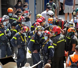 French and Lebanese firemen search in the rubble of a building after the Tuesday explosion at the seaport of Beirut, in Beirut, Lebanon, Thursday, Aug. 6, 2020.