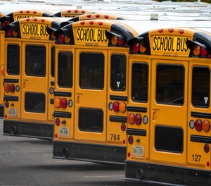In this July 24, 2020 file photo, Fairfax County Public School buses are lined up at a maintenance facility in Lorton, Va.