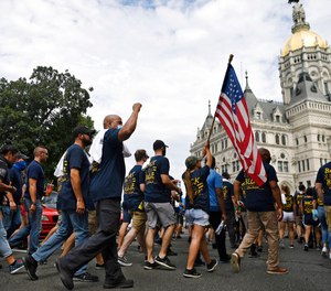 In this July 23, 2020, file photo, people participating in a