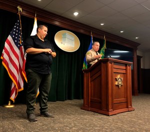 Los Angeles County Sheriff Alex Villanueva, right, announces the rollout of body-worn cameras for deputies during a news conference in Los Angeles on Wednesday, Aug. 12, 2020.