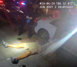 This June 29, 2018 video image from a police officer's body cam shows Jason Washington after he was shot and killed by university police officers in Portland, Ore.