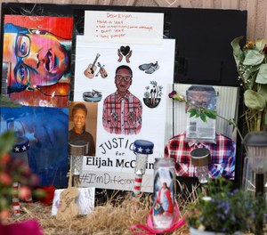A makeshift memorial stands at a site across the street from where Elijah McClain was stopped by Aurora, Colo., Police Department officers while walking home, before family members hold a news conference on July 3, 2020, in Aurora, Colo.