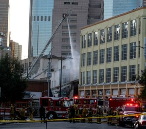 LAFD firefighters work the scene of a structure fire that injured multiple members in downtown Los Angeles.