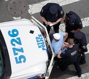 New York City police officers detain and question a man, Tuesday, July 11, 2017, in the Bronx borough of New York. (AP Photo/Mark Lennihan, File)